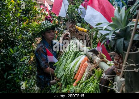 Residents do a procession by bringing natural products from agriculture and plantations called the earth alms tradition Stock Photo