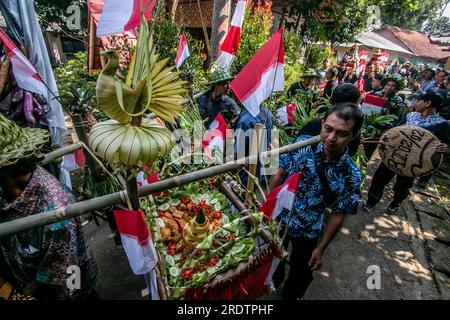 Residents do a procession by bringing natural products from agriculture and plantations called the earth alms tradition Stock Photo