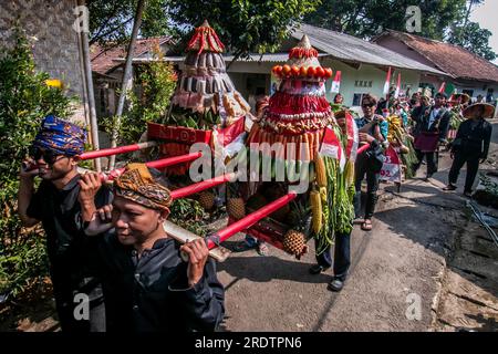 Residents do a procession by bringing natural products from agriculture and plantations called the earth alms tradition Stock Photo