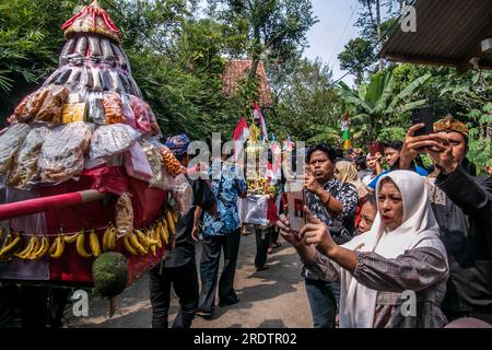 Residents do a procession by bringing natural products from agriculture and plantations called the earth alms tradition Stock Photo