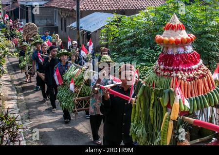 Residents do a procession by bringing natural products from agriculture and plantations called the earth alms tradition Stock Photo