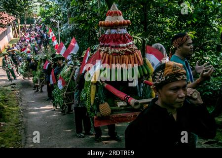 Residents do a procession by bringing natural products from agriculture and plantations called the earth alms tradition Stock Photo