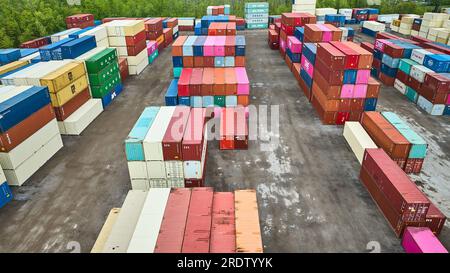 Pastel colored shipping containers aerial, rows of colorful semi truck trailers in shipping yard Stock Photo