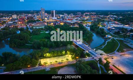 Night lights in skate park near MLK bridge leading into nightlife downtown Fort Wayne aerial Stock Photo