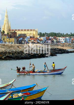 Fishermen at work in the back pilgrimage Church of Our Lady of Ransom Our Lady of Joy founded by St. Francis Xavier in 1540, Kanyakumari, Tamil Nadu Stock Photo