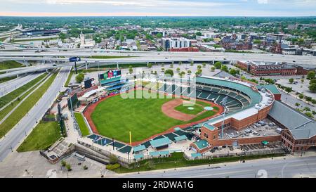 Criss crossing suspended highway roads behind aerial Louisville Slugger Field empty baseball diamond Stock Photo