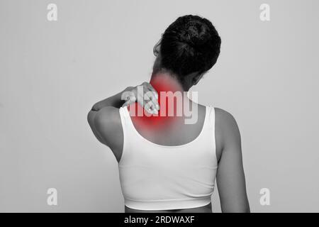 African lady rubbing sore neck after waking up in morning Stock Photo