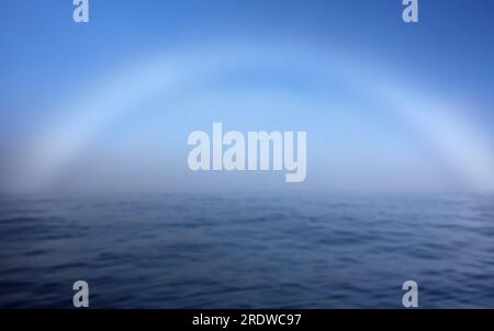 A fogbow over Arctic Ocean near North Cape in Northern Norway on late summer day in August 2022. Stock Photo