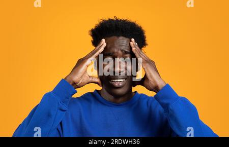 Stressed young african american man feel pain Stock Photo