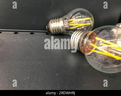 glass lamp, electrician for the apartment. incandescent light bulb for light in the house. bright chandeliers. light bulbs are on a shop window, a she Stock Photo