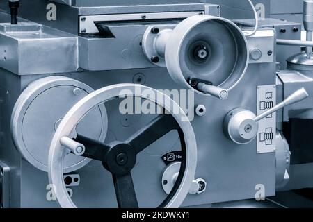 Lathe control knobs close up blue tone. Metal machine tools industry. The metalworking process by turning machine. industry metal processing concept b Stock Photo