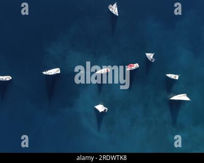 Aerial drone ultra wide panoramic photo of beautiful sail boat with white sails cruising deep blue sea near Mediterranean destination Stock Photo