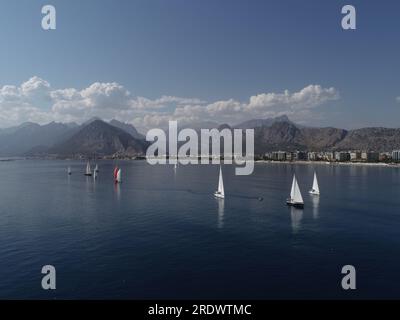 Aerial drone ultra wide panoramic photo of beautiful sail boat with white sails cruising deep blue sea near Mediterranean destination Stock Photo