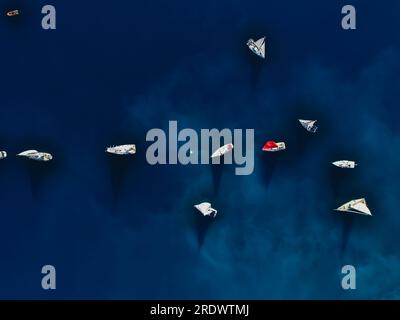 Aerial drone ultra wide panoramic photo of beautiful sail boat with white sails cruising deep blue sea near Mediterranean destination Stock Photo