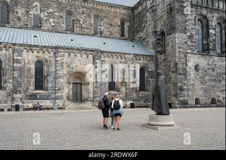 tourists in front of the Schartau statue at Lund Cathedral, Sweden, July 19, 2023 Stock Photo