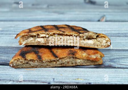 Traditional Egyptian dish Hawawshi, pita stuffed with chicken and spiced with onions, pepper, parsely and chilies, baked by filling flat Egyptian brea Stock Photo