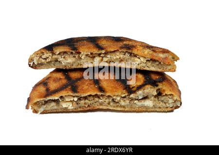 Traditional Egyptian dish Hawawshi, pita stuffed with chicken and spiced with onions, pepper, parsely and chilies, baked by filling flat Egyptian brea Stock Photo