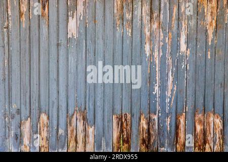 Chipped paint, old, weather worn wood slats of building, fence, decaying boards Stock Photo