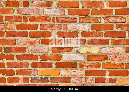 Decaying red brick wall with textured white bricks background asset Stock Photo