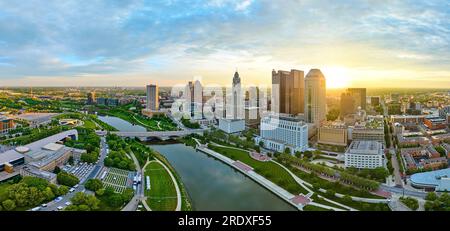 Panorama golden glowing sun at sunrise behind skyscrapers of downtown Columbus Ohio aerial Stock Photo