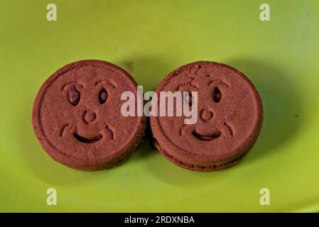 a pair of smiley shaped brown biscuits Stock Photo