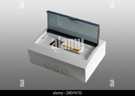 Plastic distribution board. Electrical board. Close-up. Isolated on light gray background. Stock Photo