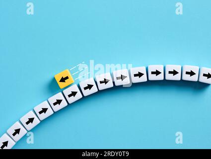 Going to the opposite direction. Standing out from the crowd. Difference, individuality and creativity. Following your own way. Stock Photo