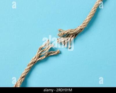 Tension, separation, danger or risk concepts. Frayed rope is about to ...