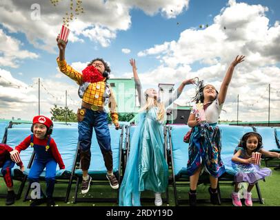 EDITORIAL USE ONLY Children take their seats at a summer daytime screening of The Super Mario Bros. Movie at Rooftop Film Club, Peckham. Issue date: Monday July 24, 2023. Stock Photo