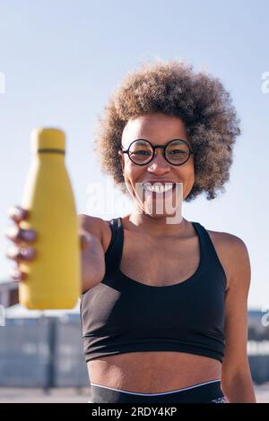 runner showing a water bottle while smiling Stock Photo - Alamy