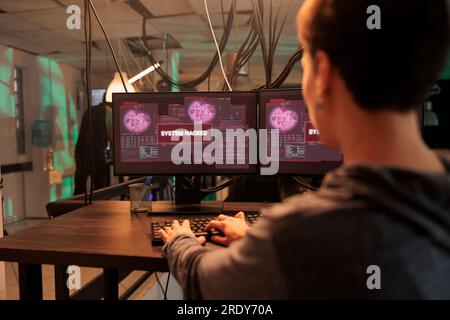 Hacker breaking into computer system, hacking bank account, stealing finances, sending virus. Cyberattack, woman creating malicious software, personal data information leak Stock Photo
