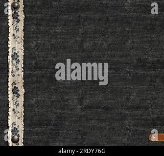Black denim background with lace borders and small leather label. Dark grey denim jeans fabric texture and vintage lace tape. Mock up template. Copy s Stock Photo