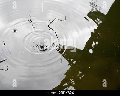 Underneath an abandoned railway bridge over the River Thames at Kennington, a vision of the abstract beauty of reflections and ripples. Stock Photo
