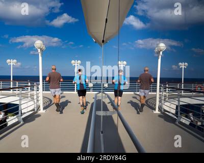 Running tracks are my secret weapon and favoured shooting venue when on board cruise liners. Not only does slogging around them help in the fight agai Stock Photo