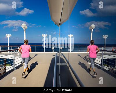 Running tracks are my secret weapon and favoured shooting venue when on board cruise liners. Not only does slogging around them help in the fight agai Stock Photo