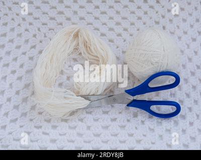 Scandinavian gnome with long beard red hat white knit background step by step handmade tutorial. Homemade fabric swedish Christmas decoration DIY. Hob Stock Photo
