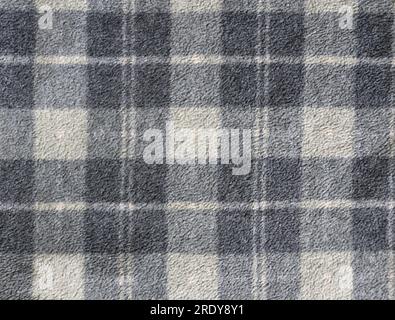 Fleece texture background with plaid pattern of grey dark grey and light grey colors. Gray fleece fabric texture with checkered pattern Stock Photo