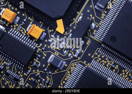 Closeup of Printed Circuit Board with processor, integrated circuits and many other surface mounted passive electrical components. Stock Photo