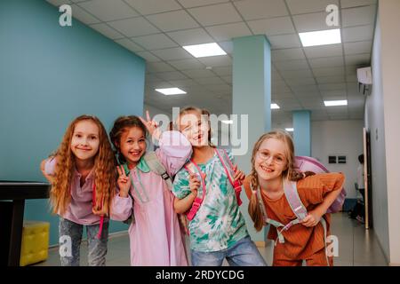 Smiling schoolgirls standing in school corridor Stock Photo
