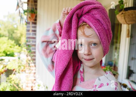 Girl with towel wrapped on head in balcony Stock Photo