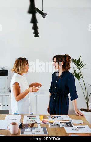 Colleagues discussing at desk in creative office Stock Photo