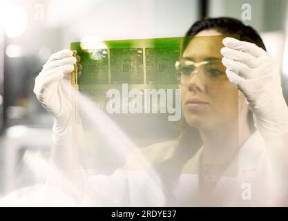 Engineer examining printed circuit board in industry Stock Photo