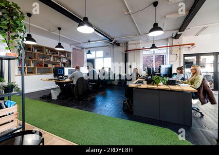 Businesswomen with businessmen working together in office Stock Photo