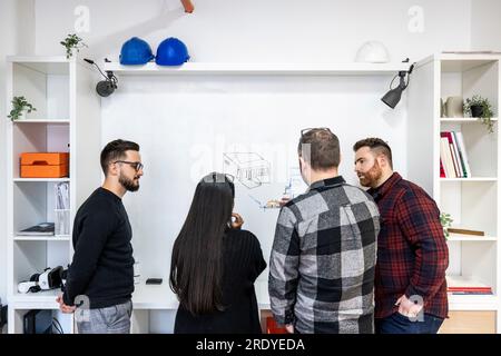 Architects working on white board in office Stock Photo