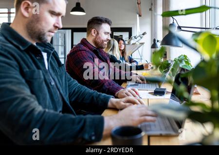 Businessmen working on laptop in office Stock Photo