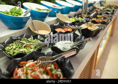 Salads with fresh vegetables in bowls on the buffet table in the hotel restaurant. Stock Photo