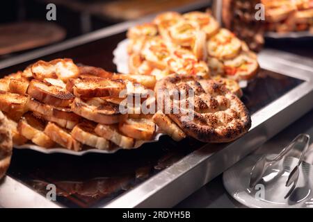Turkish pita bread with bruschetta on buffet table in hotel restaurant. Stock Photo