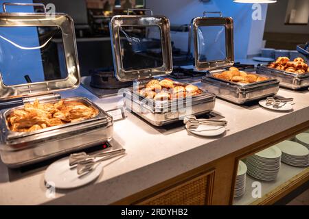 A buffet counter with fresh pastries in the hotel restaurant with a breakfast menu. Stock Photo