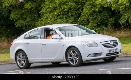 Milton Keynes,UK - July 21st 2023: 2012 white diesel engine Vauxhall Insignia car driving on an English road Stock Photo