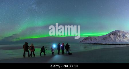 Photographers on Skagsanden beach during Northern Lights, Norway Stock Photo